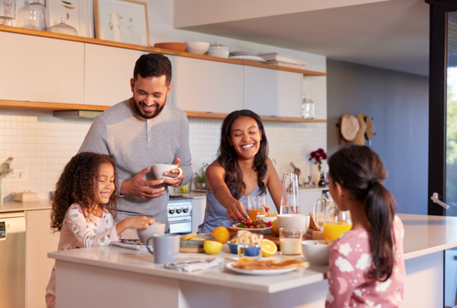 Family talking around the kitchen counter